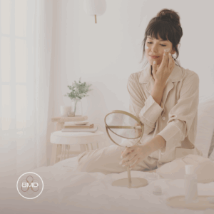 You Deserve Guilt-Free Self-Care - Here’s Why 1 Woman embracing guilt-free self-care with a calming skincare routine, gently applying moisturizer while looking in the mirror