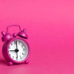 aesthetic pink alarm clock and background