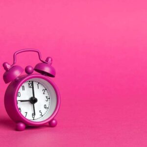 aesthetic pink alarm clock and background