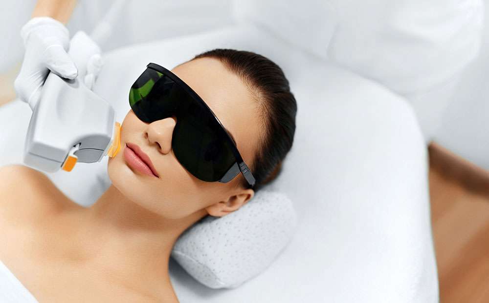 Young Woman Receiving Intense Pulsed Light Therapy